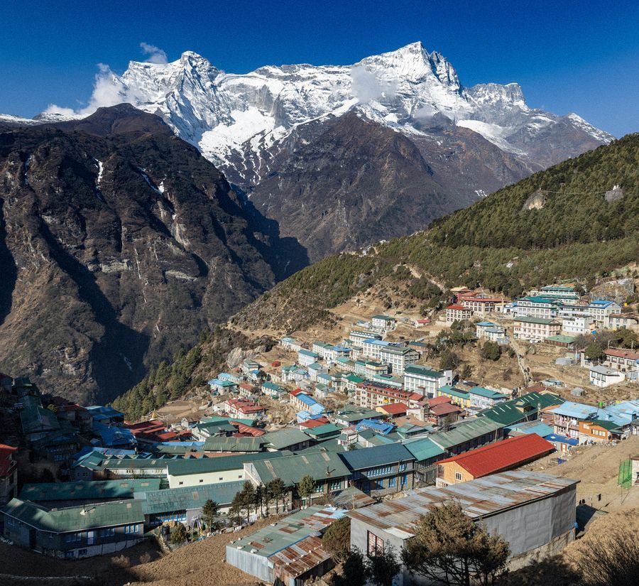 The village of Namche Bazaar spread across the hillside beneath snow peaks